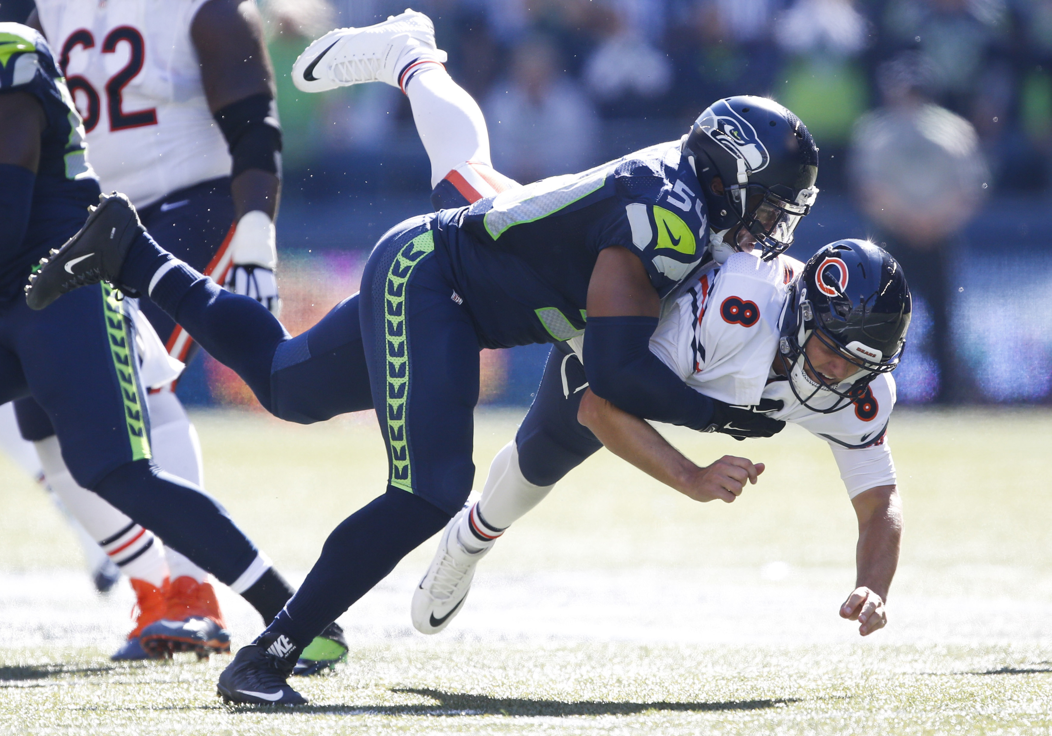 Baltimore Ravens' quarterback Jimmy Clausen passes under heavy