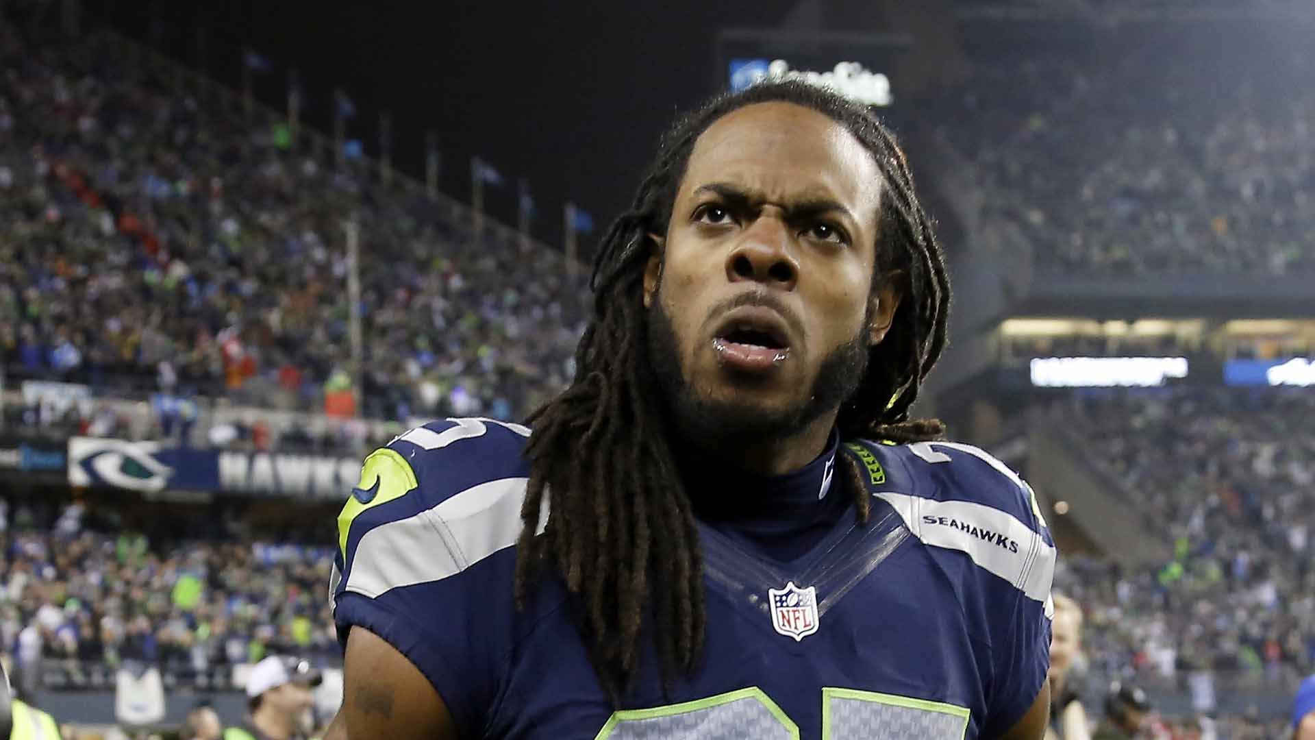 Seattle Seahawks head coach Pete Carroll talks things over with cornerback  Richard Sherman (25) while on the sidelines during the Super Bowl XLVIII at  MetLife Stadium in East Rutherford, New Jersey on